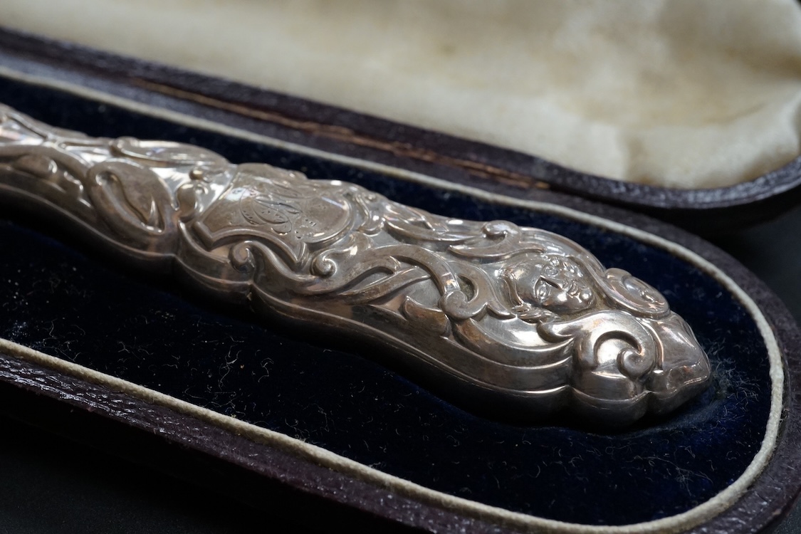A cased set of twelve Edwardian silver apostle teaspoons with a pair of sugar tongs, Cooper Brothers & Sons, Sheffield, together with a cased Victorian silver bread knife and a cased set of six silver handled steel tea k